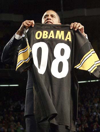 US Democratic presidential nominee Barack Obama holds up a Pittsburgh Steelers football jersey given to him by Dan Rooney, chairman of the Pittsburgh Steelers football team, during a campaign rally in Pittsburgh, Pennsylvania, October 27, 2008.